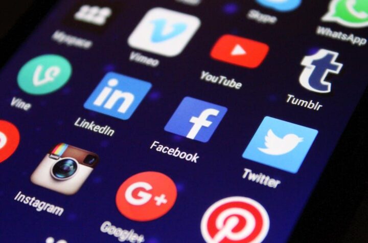 Free Close-up of a smartphone screen showing various social media app icons such as Facebook and Twitter. Stock Photo